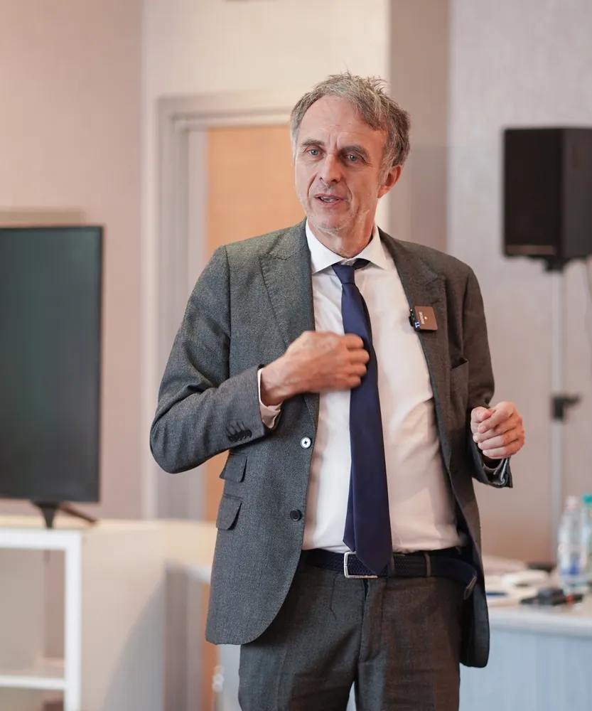 Dr. Marco Paret standing in a conference room, teaching